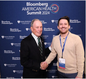 Cody Ingle shakes hands with Mike Bloomberg.