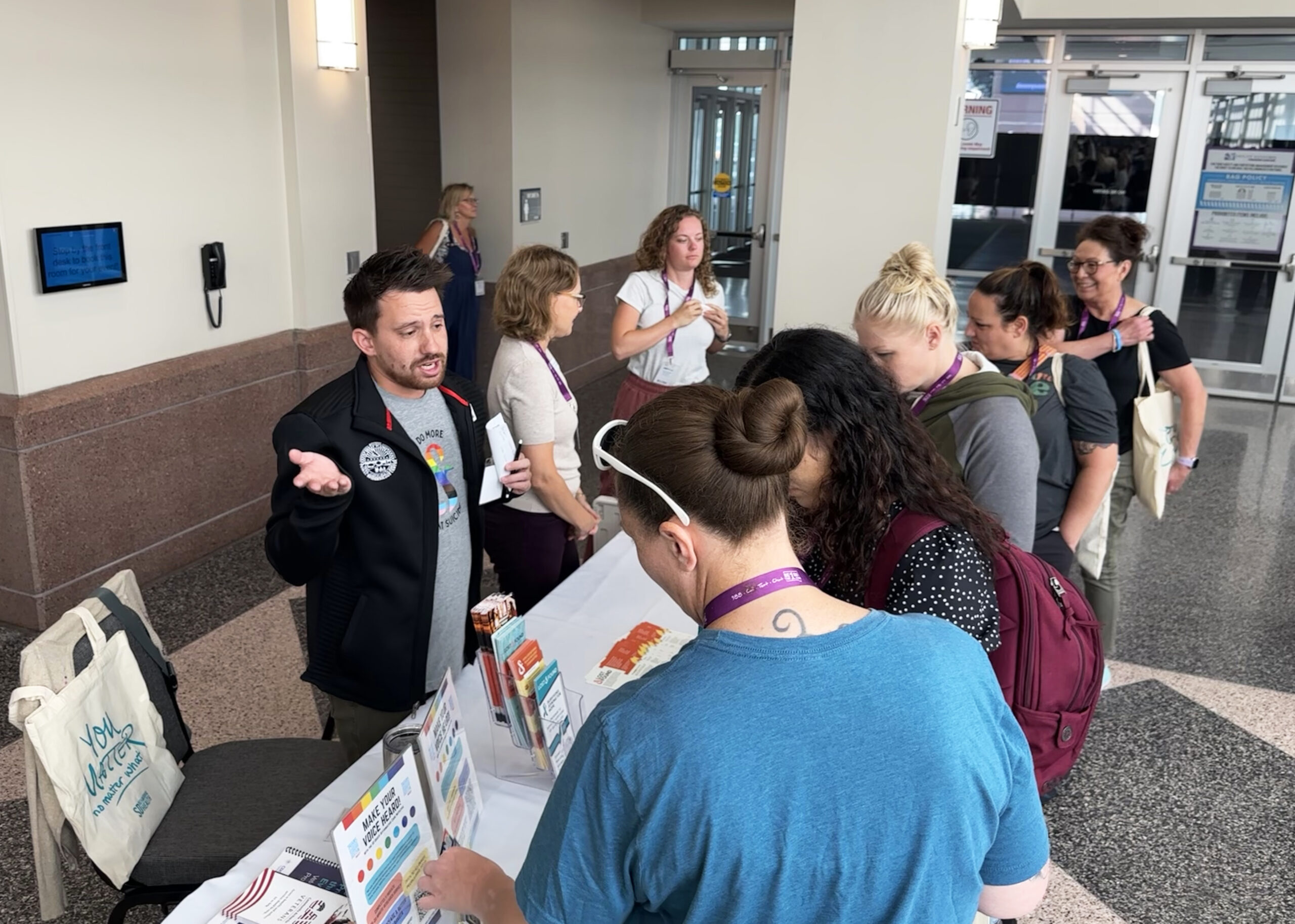 People stand in front of Lost&Found's table at the South Dakota Suicide Prevention Conference on August 1. Staff members Cody Ingle, Gesine Ziebarth, and Dakotah Jordan are pictured.